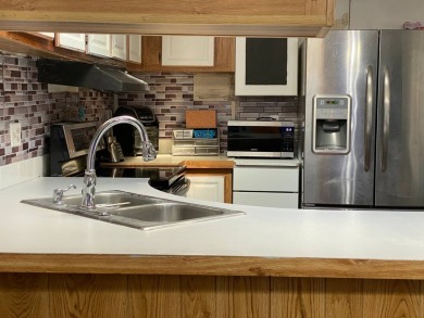 This 2/1.5 manufactured home is priced to sell. It is nestled up on Lake Henry Golf Club in Florida - for sale on GolfHomes.com, golf home, golf lot