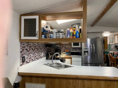 This 2/1.5 manufactured home is priced to sell. It is nestled up on Lake Henry Golf Club in Florida - for sale on GolfHomes.com, golf home, golf lot