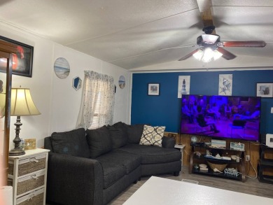 This 2/1.5 manufactured home is priced to sell. It is nestled up on Lake Henry Golf Club in Florida - for sale on GolfHomes.com, golf home, golf lot