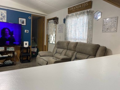 This 2/1.5 manufactured home is priced to sell. It is nestled up on Lake Henry Golf Club in Florida - for sale on GolfHomes.com, golf home, golf lot