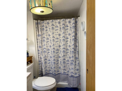 This 2/1.5 manufactured home is priced to sell. It is nestled up on Lake Henry Golf Club in Florida - for sale on GolfHomes.com, golf home, golf lot