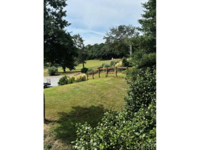 Golf course views over the thirteenth green with a spacious deck on Seascape Golf Links in North Carolina - for sale on GolfHomes.com, golf home, golf lot