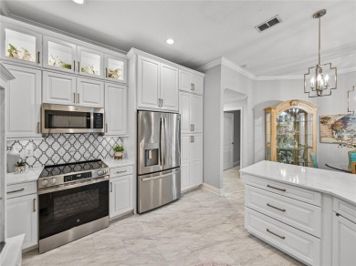 STUNNING CURB APPEAL on this GORGEOUS FULLY REMODELED PANORAMIC on Tampa Bay Golf and Country Club in Florida - for sale on GolfHomes.com, golf home, golf lot