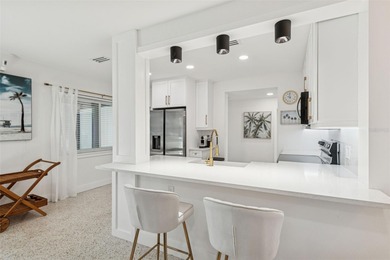 Welcome home to laid-back coastal living in the heart of Dunedin on The Dunedin Country Club in Florida - for sale on GolfHomes.com, golf home, golf lot