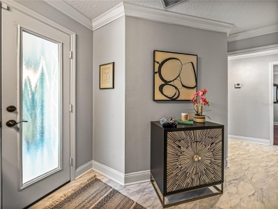 STUNNING CURB APPEAL on this GORGEOUS FULLY REMODELED PANORAMIC on Tampa Bay Golf and Country Club in Florida - for sale on GolfHomes.com, golf home, golf lot