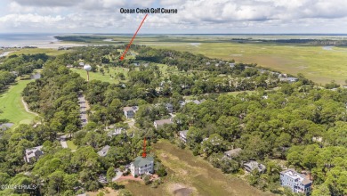 Gorgeous custom built home with enchanting marsh views. Walk to on Ocean Creek Golf Course in South Carolina - for sale on GolfHomes.com, golf home, golf lot