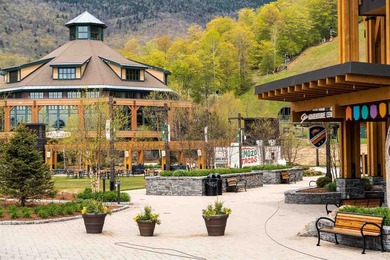 Discover The Lodge at Spruce Peak, the crown jewel of the Alpine on Stowe Mountain Club in Vermont - for sale on GolfHomes.com, golf home, golf lot