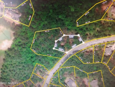 Huge .59/acre wooded home site on a beautiful street within the on Ocean Ridge Plantation in North Carolina - for sale on GolfHomes.com, golf home, golf lot