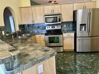 Welcome to a lovely home situated on a large corner lot in the on Caloosa Greens Executive Golf Course in Florida - for sale on GolfHomes.com, golf home, golf lot