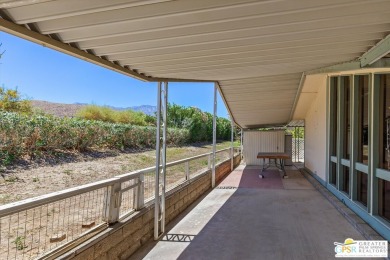 Dramatic mountain views enhance this open and light home behind on Date Palm Country Club in California - for sale on GolfHomes.com, golf home, golf lot
