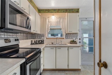 MOVE-IN READY! 2 BED/2 BATH COZY RETREAT - TWO FLORIDA ROOMS - on Bay Tree Golf Course in Florida - for sale on GolfHomes.com, golf home, golf lot
