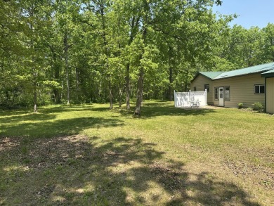 This well kept 2 bedroom is in a great location with paved road on Marquette Trails Country Club in Michigan - for sale on GolfHomes.com, golf home, golf lot