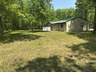 This well kept 2 bedroom is in a great location with paved road on Marquette Trails Country Club in Michigan - for sale on GolfHomes.com, golf home, golf lot