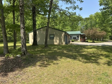 This well kept 2 bedroom is in a great location with paved road on Marquette Trails Country Club in Michigan - for sale on GolfHomes.com, golf home, golf lot