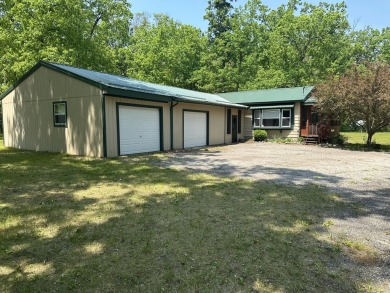 This well kept 2 bedroom is in a great location with paved road on Marquette Trails Country Club in Michigan - for sale on GolfHomes.com, golf home, golf lot