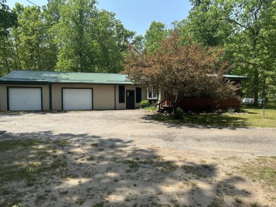 This well kept 2 bedroom is in a great location with paved road on Marquette Trails Country Club in Michigan - for sale on GolfHomes.com, golf home, golf lot