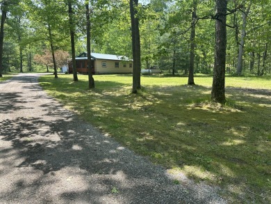This well kept 2 bedroom is in a great location with paved road on Marquette Trails Country Club in Michigan - for sale on GolfHomes.com, golf home, golf lot