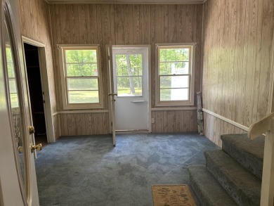 This well kept 2 bedroom is in a great location with paved road on Marquette Trails Country Club in Michigan - for sale on GolfHomes.com, golf home, golf lot