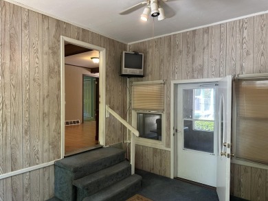 This well kept 2 bedroom is in a great location with paved road on Marquette Trails Country Club in Michigan - for sale on GolfHomes.com, golf home, golf lot