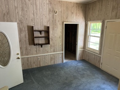 This well kept 2 bedroom is in a great location with paved road on Marquette Trails Country Club in Michigan - for sale on GolfHomes.com, golf home, golf lot