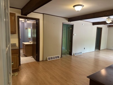 This well kept 2 bedroom is in a great location with paved road on Marquette Trails Country Club in Michigan - for sale on GolfHomes.com, golf home, golf lot