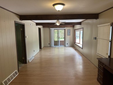 This well kept 2 bedroom is in a great location with paved road on Marquette Trails Country Club in Michigan - for sale on GolfHomes.com, golf home, golf lot