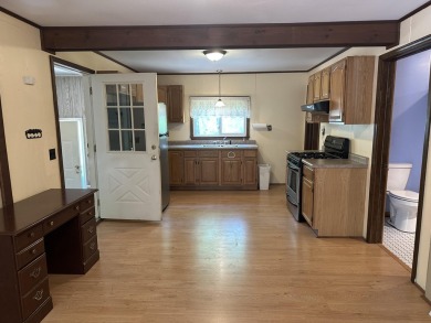 This well kept 2 bedroom is in a great location with paved road on Marquette Trails Country Club in Michigan - for sale on GolfHomes.com, golf home, golf lot