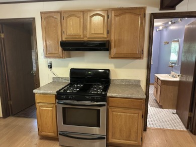 This well kept 2 bedroom is in a great location with paved road on Marquette Trails Country Club in Michigan - for sale on GolfHomes.com, golf home, golf lot