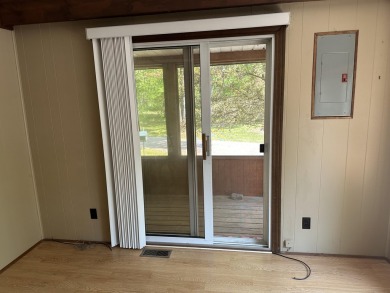 This well kept 2 bedroom is in a great location with paved road on Marquette Trails Country Club in Michigan - for sale on GolfHomes.com, golf home, golf lot