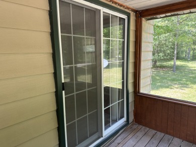 This well kept 2 bedroom is in a great location with paved road on Marquette Trails Country Club in Michigan - for sale on GolfHomes.com, golf home, golf lot