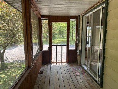 This well kept 2 bedroom is in a great location with paved road on Marquette Trails Country Club in Michigan - for sale on GolfHomes.com, golf home, golf lot