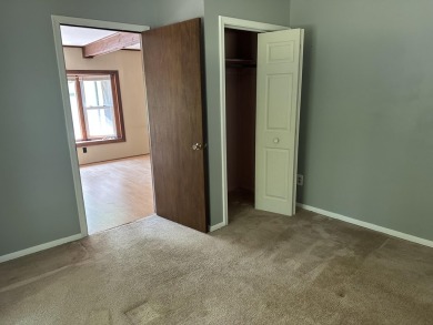 This well kept 2 bedroom is in a great location with paved road on Marquette Trails Country Club in Michigan - for sale on GolfHomes.com, golf home, golf lot