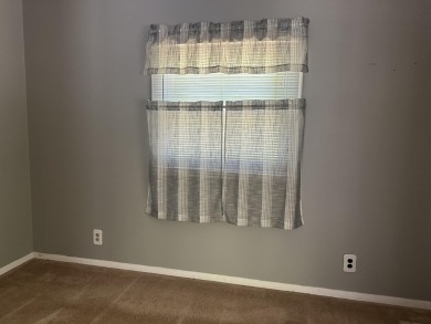 This well kept 2 bedroom is in a great location with paved road on Marquette Trails Country Club in Michigan - for sale on GolfHomes.com, golf home, golf lot