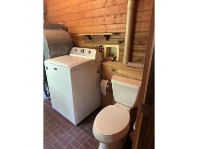 This well kept 2 bedroom is in a great location with paved road on Marquette Trails Country Club in Michigan - for sale on GolfHomes.com, golf home, golf lot