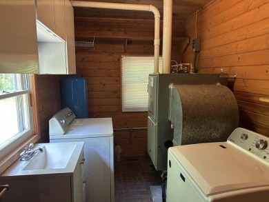This well kept 2 bedroom is in a great location with paved road on Marquette Trails Country Club in Michigan - for sale on GolfHomes.com, golf home, golf lot
