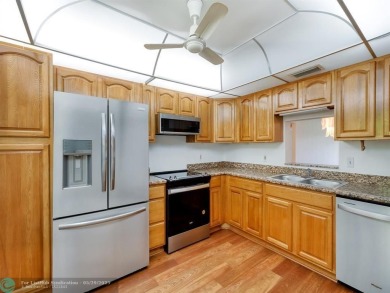 BRAND NEW VINYL FLOORING, NEVER-USED TOP-LINE SS APPLIANCES W/ on Wynmoor Golf Course in Florida - for sale on GolfHomes.com, golf home, golf lot