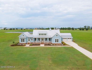 Located in the stunning gated community of Occano, this modern on Occano Golf Course in North Carolina - for sale on GolfHomes.com, golf home, golf lot