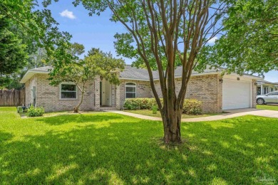 Blooming Crepe Myrtles greet you out front of this beautifully on Tiger Point Golf and Country Club in Florida - for sale on GolfHomes.com, golf home, golf lot