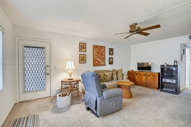 Enjoy serene lake and golf course views from this first-floor on Flamingo Lakes Country Club in Florida - for sale on GolfHomes.com, golf home, golf lot