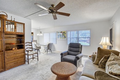 Enjoy serene lake and golf course views from this first-floor on Flamingo Lakes Country Club in Florida - for sale on GolfHomes.com, golf home, golf lot