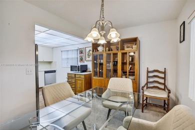 Enjoy serene lake and golf course views from this first-floor on Flamingo Lakes Country Club in Florida - for sale on GolfHomes.com, golf home, golf lot