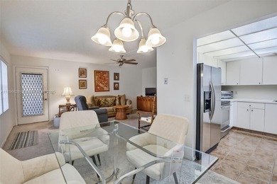 Enjoy serene lake and golf course views from this first-floor on Flamingo Lakes Country Club in Florida - for sale on GolfHomes.com, golf home, golf lot