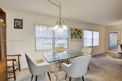 Enjoy serene lake and golf course views from this first-floor on Flamingo Lakes Country Club in Florida - for sale on GolfHomes.com, golf home, golf lot