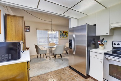 Enjoy serene lake and golf course views from this first-floor on Flamingo Lakes Country Club in Florida - for sale on GolfHomes.com, golf home, golf lot