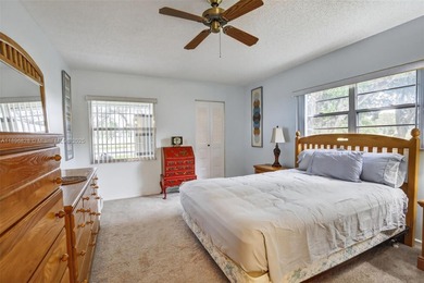 Enjoy serene lake and golf course views from this first-floor on Flamingo Lakes Country Club in Florida - for sale on GolfHomes.com, golf home, golf lot