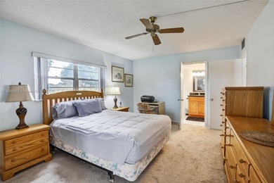 Enjoy serene lake and golf course views from this first-floor on Flamingo Lakes Country Club in Florida - for sale on GolfHomes.com, golf home, golf lot