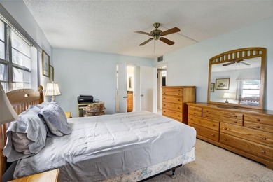 Enjoy serene lake and golf course views from this first-floor on Flamingo Lakes Country Club in Florida - for sale on GolfHomes.com, golf home, golf lot