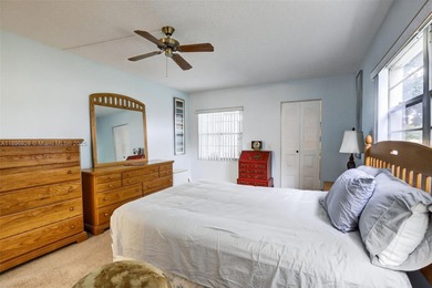 Enjoy serene lake and golf course views from this first-floor on Flamingo Lakes Country Club in Florida - for sale on GolfHomes.com, golf home, golf lot