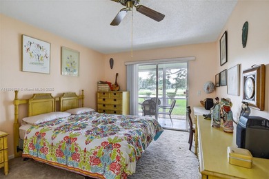 Enjoy serene lake and golf course views from this first-floor on Flamingo Lakes Country Club in Florida - for sale on GolfHomes.com, golf home, golf lot