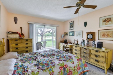 Enjoy serene lake and golf course views from this first-floor on Flamingo Lakes Country Club in Florida - for sale on GolfHomes.com, golf home, golf lot
